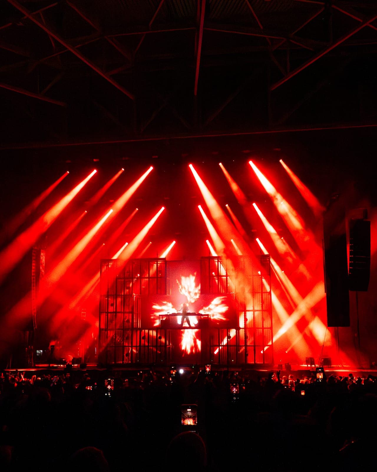 Red beams fan down to Martin Garrix's cube stage as a fiery phoenix fills the screen at RBC Amphitheatre in Toronto
